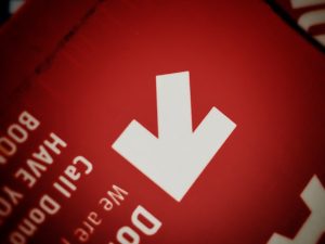 White arrow on red background, text visible.