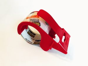 Red tape dispenser with packaging tape roll.
