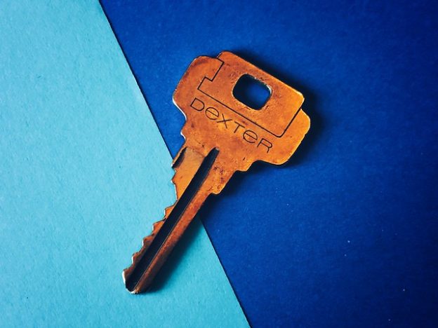 Bronze key on blue background.