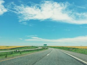 Open highway under a clear blue sky.